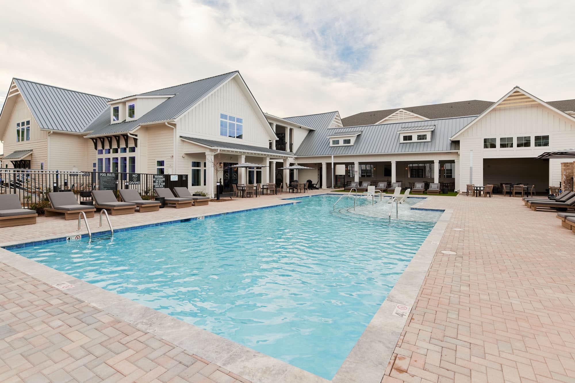 Stead at farmington pool with community behind it, apartment with pool